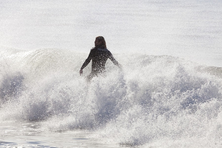 Santa Cruz, USA, November 25, 2014: Athlete surfing on Santa Cruz beach in California. November 25, 2014のeditorial素材