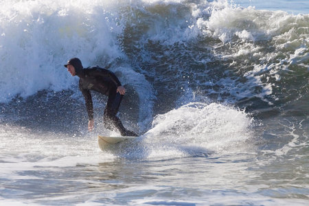 Santa Cruz, USA, November 25, 2014: Athlete surfing on Santa Cruz beach in California. November 25,...