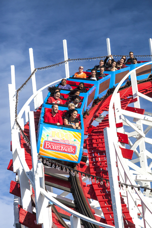 Santa Cruz, California, USA-November 15, 2014 : People on Giant Dipper the fifth oldest wooden coaster in the US. Built by Arthur Looff in 1924 and maximum speed is up to 46 mph. Taken in Santa Cruz Beach Boardwalk`s Park.のeditorial素材