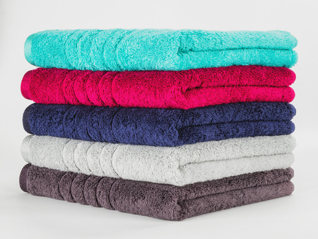 Pile of Multicolored towels on a white backgroundの写真素材