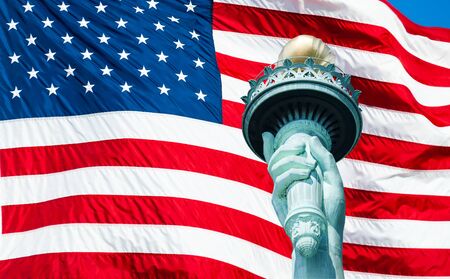 Statue of Liberty torch at New York City and US Flagの写真素材