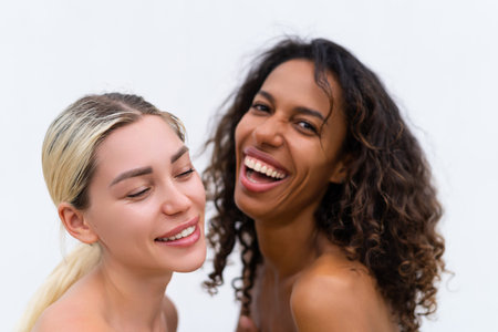 Woman close beauty portrait mixed race black skin and white skin, two female on white background