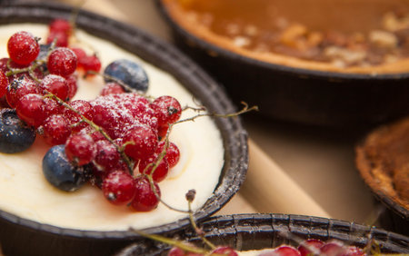 cakes with red currant and blueberries on the window of the cafe