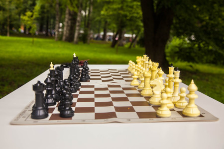 a game of chess in the Park on a green backgroundの写真素材
