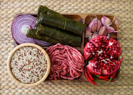 Raw ingredients for cooking dolma. Grape leaves, beef and pomegranate. top viewの写真素材