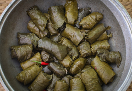 Delicious homemade stuffed grape leaves, the traditional dolma of the mediterranean cuisine in a cooking pot. Close-up.の写真素材