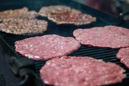 To roast hamburgers and hot dogs on a large grill in the open air. Outdoor cafes