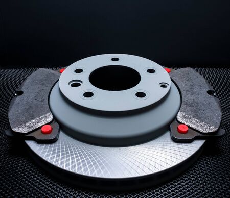 New brake disc and pads for the car. On black backgroundの写真素材