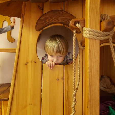 The brooding boy hid in his toy houseの写真素材