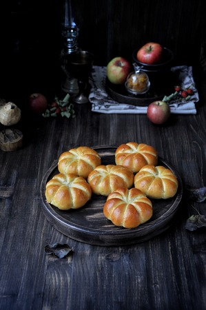 Fresh buns in the form of a pumpkin, with apple stuffingの写真素材