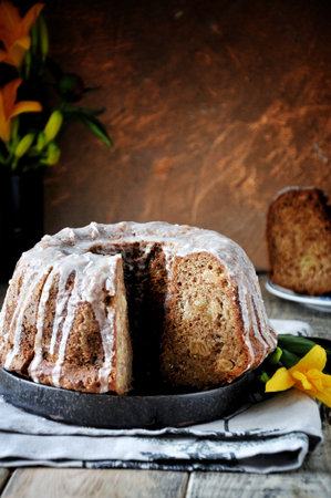 Apple cake with raisins in sugar glaze