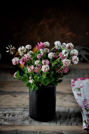On the table in a vase a bouquet of flowers, a cloverの写真素材