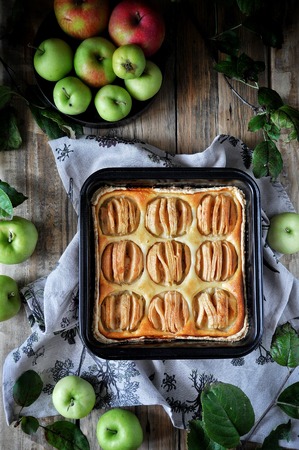 On the stand is a curd cake with apples. Fresh applesの写真素材