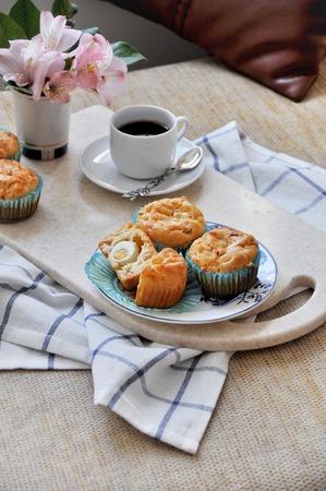 Homemade snack cakes stuffed with ham, cheese and quail eggs. Morning breakfast in bedの写真素材