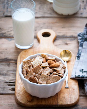 Dry healthy breakfast with nuts and a glass of milkの写真素材