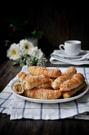 On a wooden table on a platter fresh bananas baked in a doughの写真素材