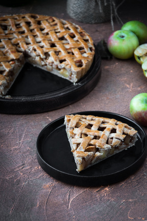 Apple pie with a lattice of whole-grain dough, whole and in piecesの写真素材