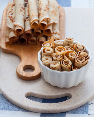 Thin pancakes for breakfast. Maslenitsa. On the table, a dish with pancakes, coffee and jam from feijoaの写真素材
