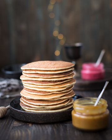 Pancakes with honey, jam and berriesの写真素材