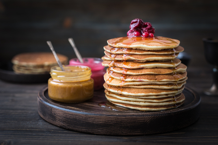Pancakes with honey, jam and berriesの写真素材
