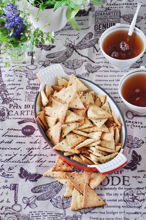 Triangular home made cracker with black and white sesameの写真素材
