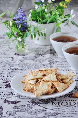 Triangular home made cracker with black and white sesameの写真素材