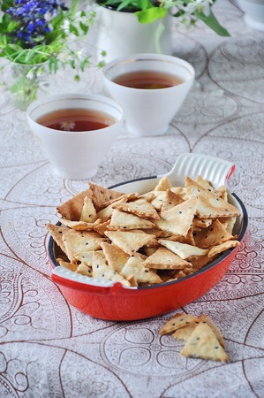 Triangular home made cracker with black and white sesameの写真素材