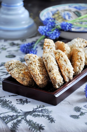 Homemade oat biscuits, cookies with sesame seeds, decorated with spring flowersの写真素材