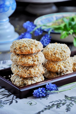 Homemade oat biscuits, cookies with sesame seeds, decorated with spring flowersの写真素材