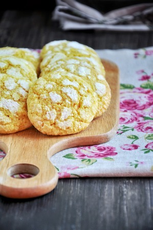 Coconut biscuits tinted with turmeric. On the chopping boardの写真素材