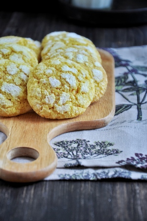 Coconut biscuits tinted with turmeric. On the chopping boardの写真素材