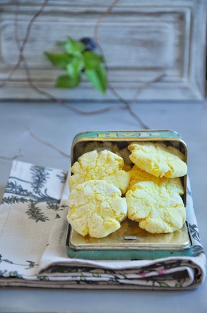 Coconut biscuits tinted with turmeric. In a metal jarの写真素材