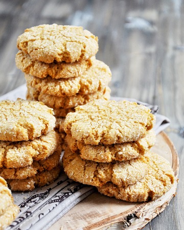 Stacks of homemade honey biscuits with cracks added with coconutの写真素材