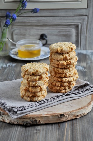 Stacks of homemade honey biscuits with cracks added with coconutの写真素材