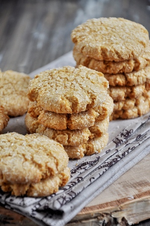 Stacks of homemade honey biscuits with cracks added with coconutの写真素材
