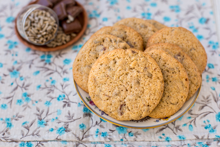 Homemade cookies from whole wheat flour with chocolate and seeds, on a platterの写真素材