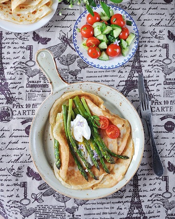 Breakfast of pancakes baked with asparagus with boiled egg and cream cheeseの写真素材