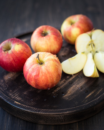 On a wooden stand. Fresh red apples. Wooden backgroundの写真素材