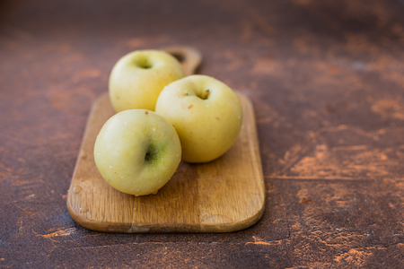 Fresh apples. Variety White pouring on a wooden cutting boardの写真素材