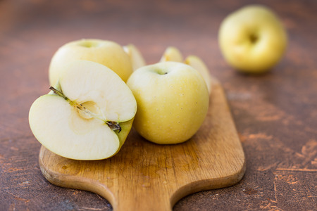 Fresh apples. Variety White pouring on a wooden cutting boardの写真素材