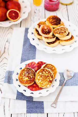 Curd cheese cakes with honey and red orangesの写真素材