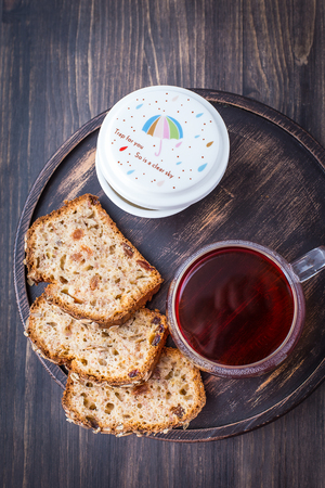 Banana cake with seeds and a cup of hot teaの写真素材