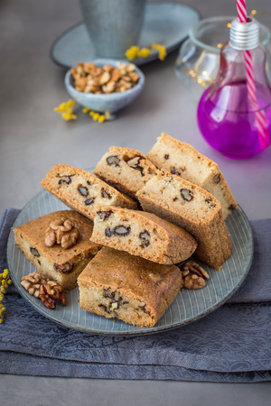 On the plate of mannik with walnuts. Blondie. In pieces. Decorated with mimosa flowersの写真素材