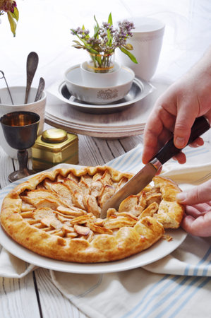 On the table on a white plate of galette with applesの写真素材