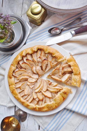 On the table on a white plate of galette with apples