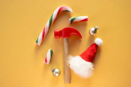 Christmas composition with candy canes, ornaments and toy hammerの写真素材