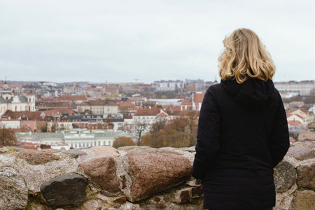 Woman looking at the panorama of Vilnius Old Town from aboveの写真素材
