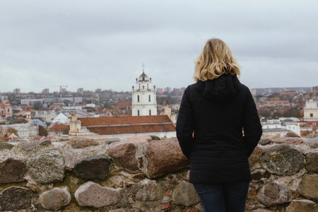 Woman looking at the panorama of Vilnius Old Town from aboveの写真素材