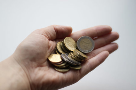 Woman holding euro coins in her hand, close-up. High quality photo