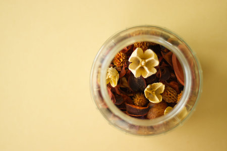 Dried flowers and botanical potpourri in glass jar, top view